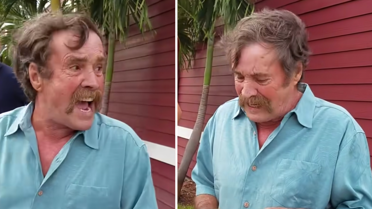 man in a blue shirt looking surprised and crying