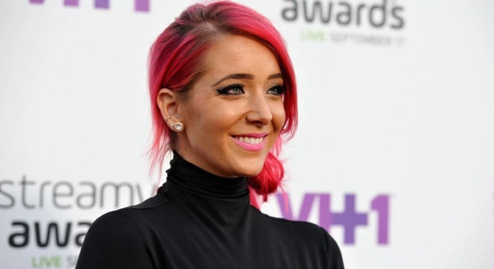 Jenna Marbles with red hair pulled back wearing a black tank top