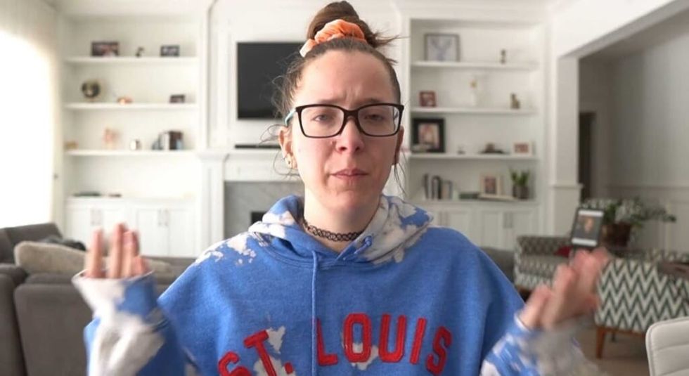 Jenna Marbles with hair up in a bun, glasses on and sweatshirt in last YouTube video.