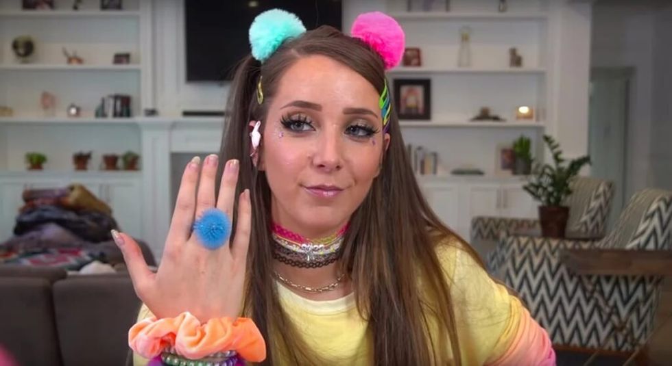 Jenna Marbles in club gear showing off blue ring.