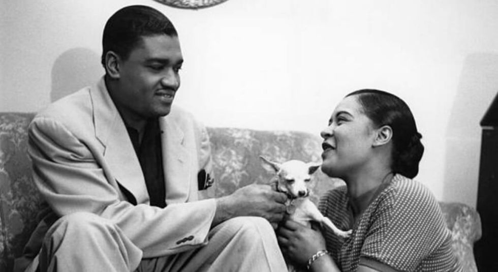 Louis McKay and Billie Holiday on the couch holding a small dog.