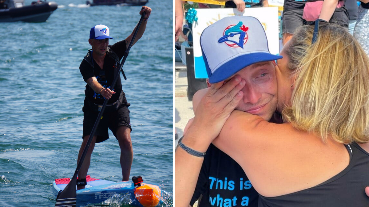 man paddleboarding and crying man hugging a woman