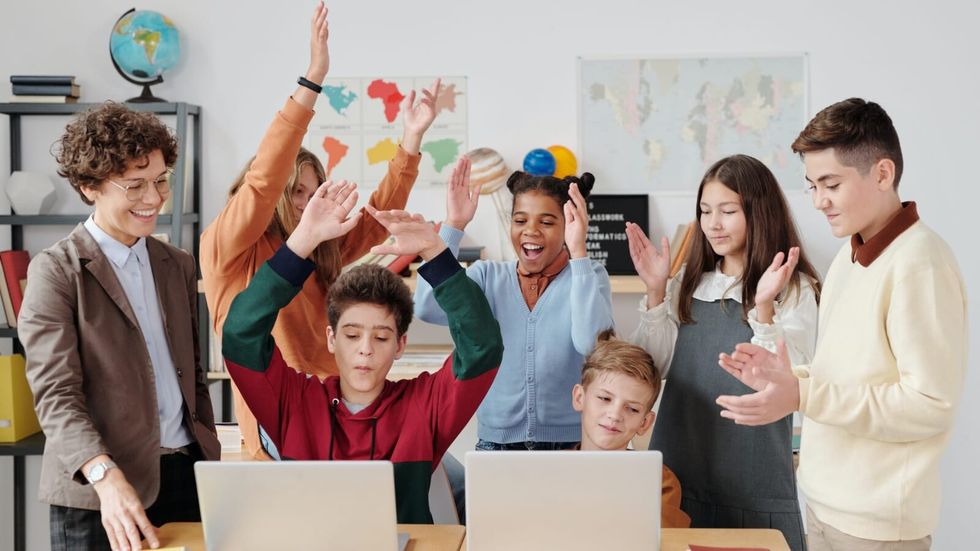 students clapping hands in a classroom