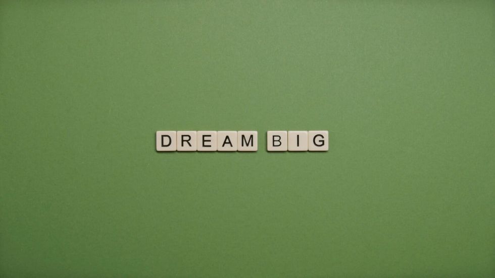 "dream big" on letters in front of a green background