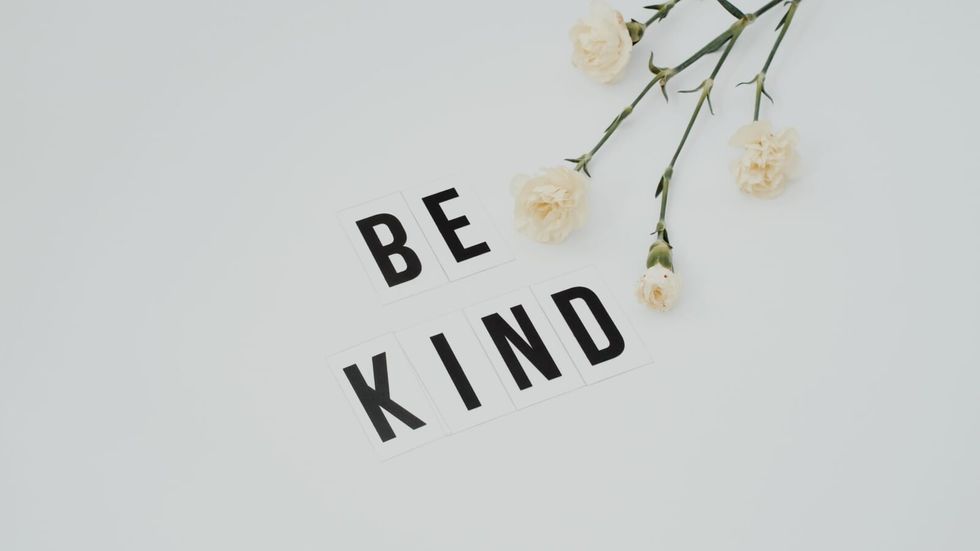 "be kind" on a white background, with flowers 