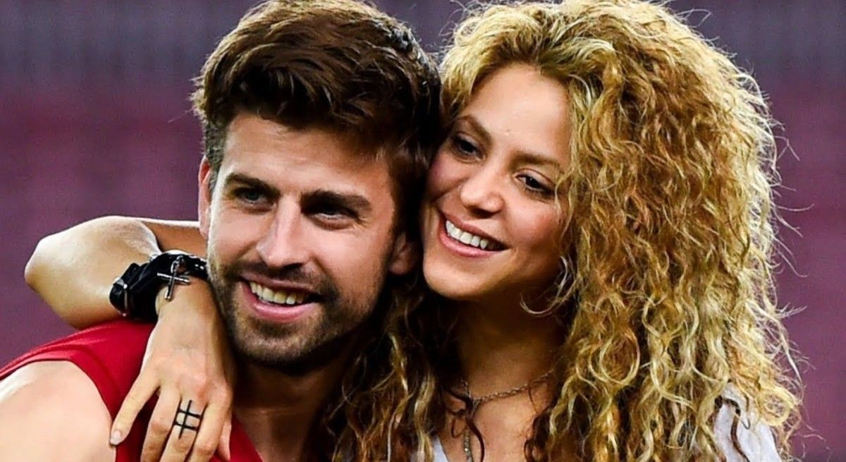 Shakira and husband Gerard Pique smiling and hugging.