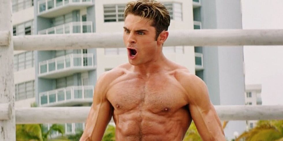 Zac Efron flexing his muscles and screaming.