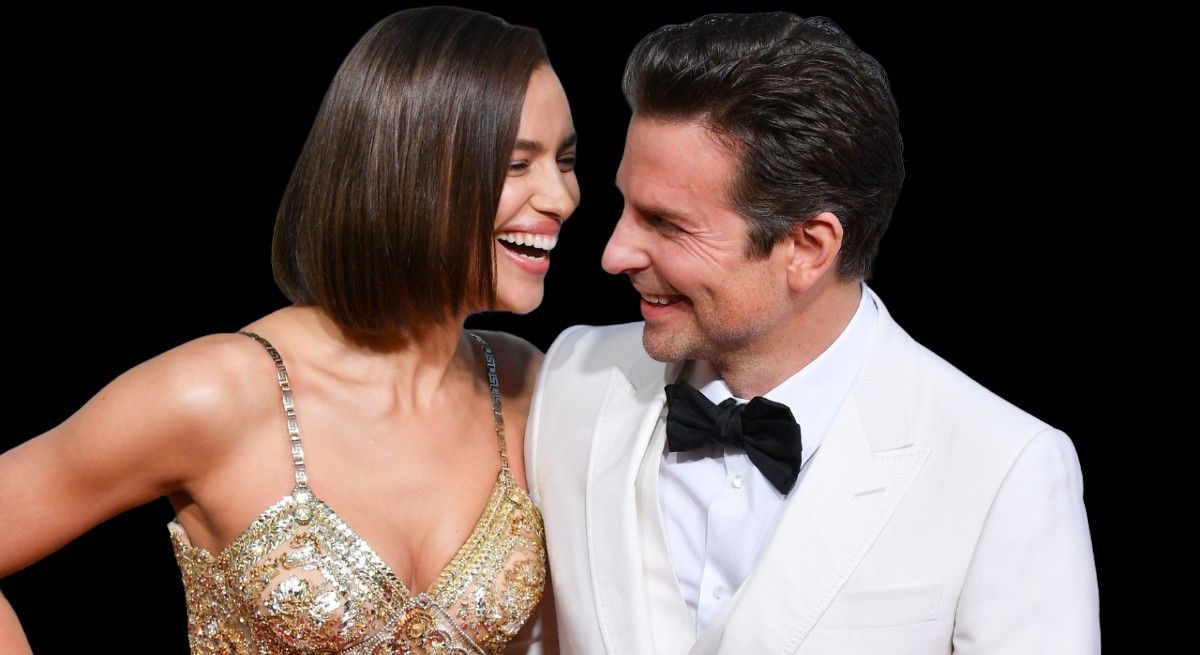 Supermodel Irina Shayk and Bradley Cooper looking at each other and laughing.