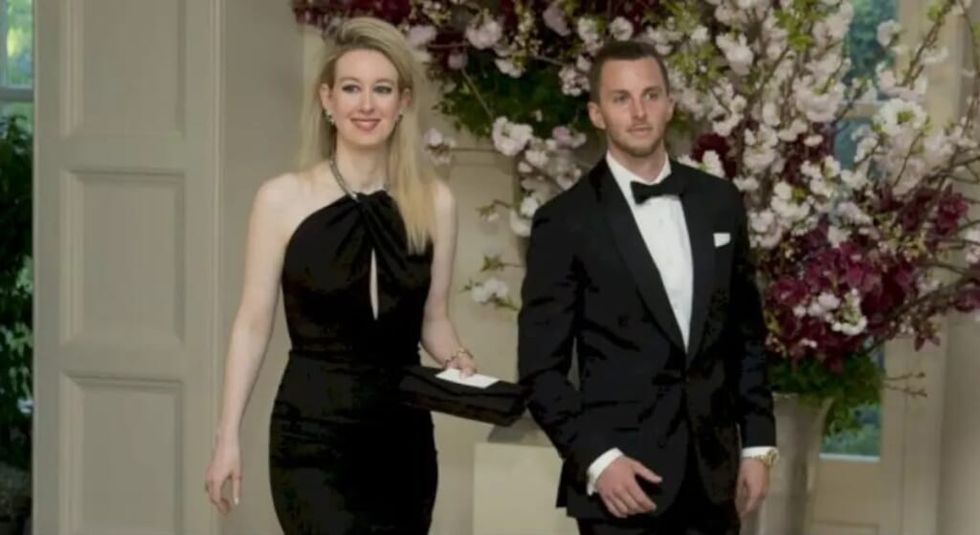 Elizabeth Holmes in black gown with husband Billy Evans.