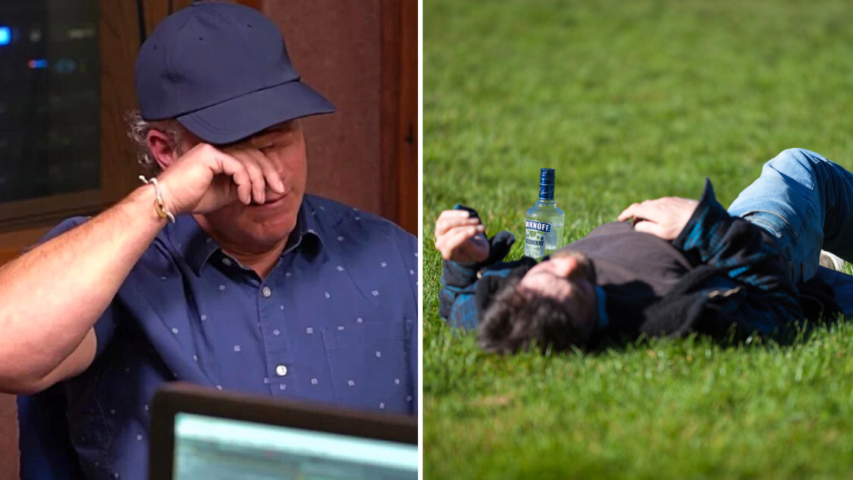 man in a hat crying a man laying on the grass with a bottle of alcohol next to him