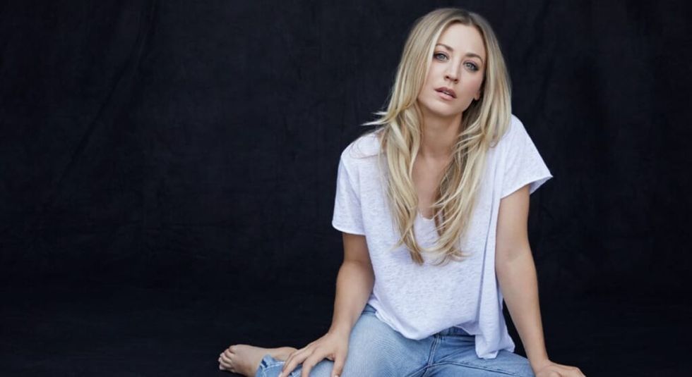 Kaley Cuoco in white shirt and jeans.