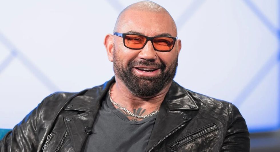 Dave Bautista in black leather jacket and black sunglasses during and interview.