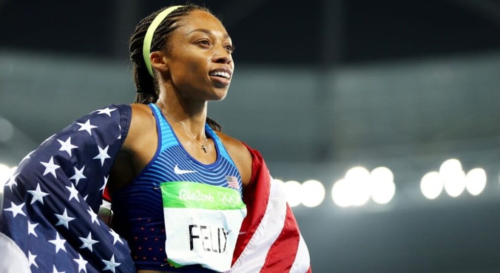 Allyson Felix after a race, wrapped in the US flag.