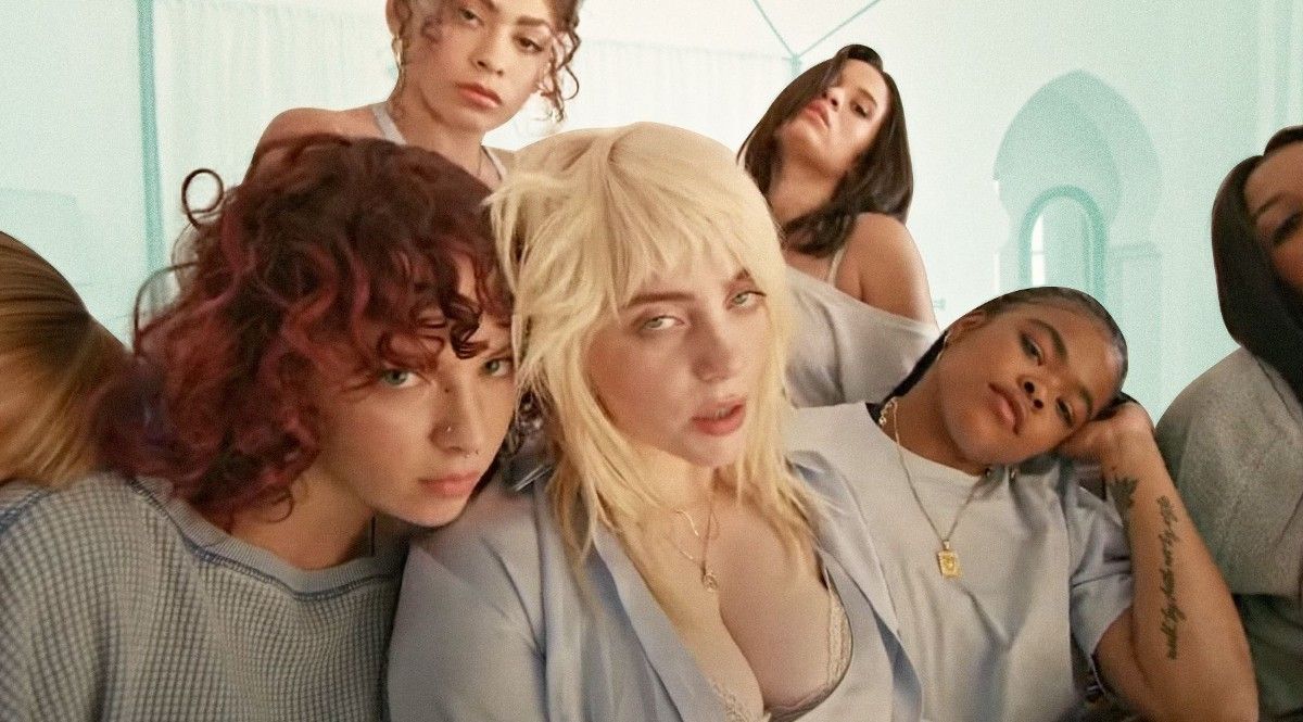 Billie Eilish with friends on bed while filming Lost Cause music video.