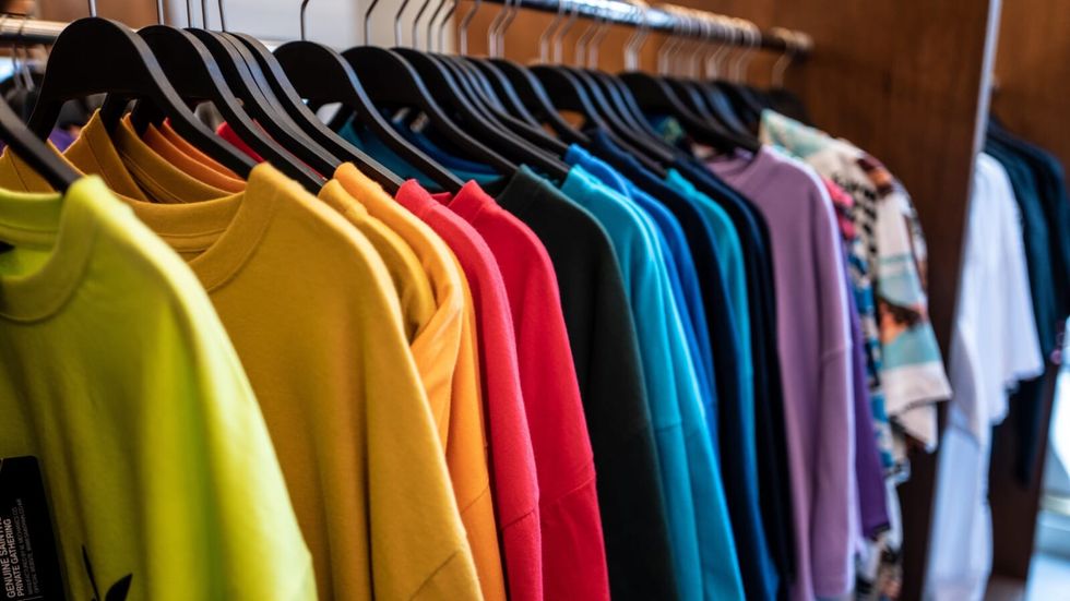 multi-colored tshirts hanging on a rack