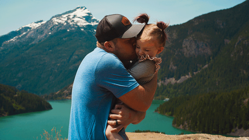 Father kissing daughter