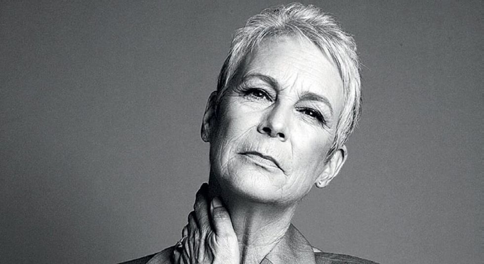 Black and white photo of Jamie Lee Curtis with hand on her neck.