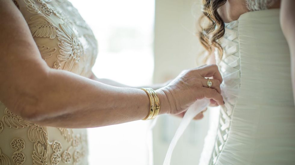 woman tying a bride's dress