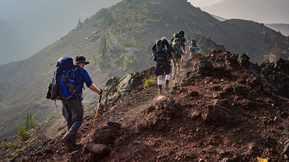 people hiking a mountain