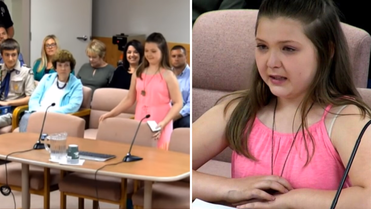 little girl in a pink outfit and preparing to sit in a chair at a board meeting