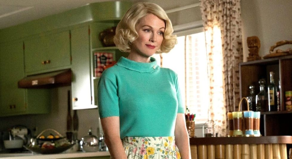 Julianne Moore in green sweater and 1950s style hair in movie Suburbicon. 