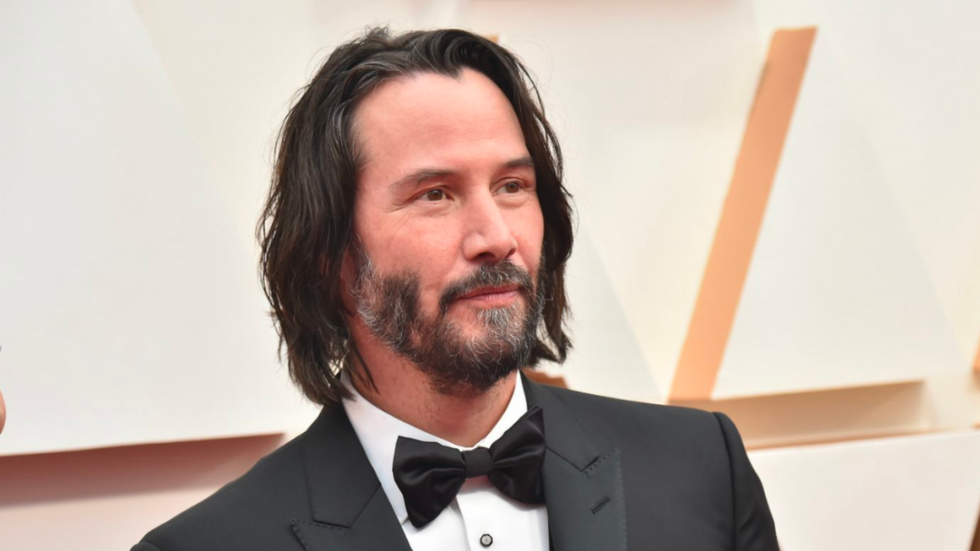 Keanu Reeves wearing a suit and bowtie.