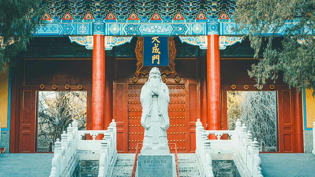 Confucius statue in front of a temple