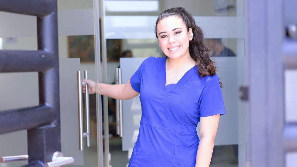 smiling nurse near a door