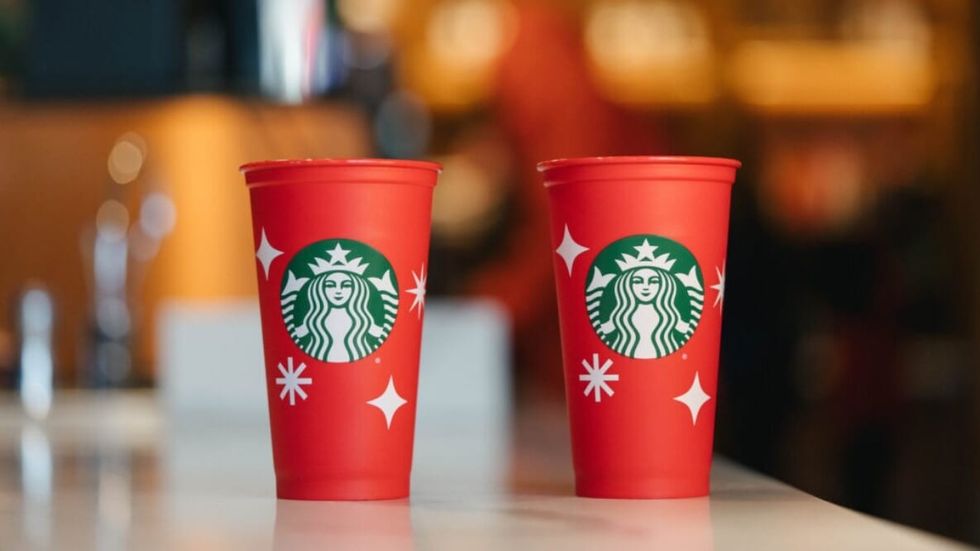 two red starbucks cups on a table