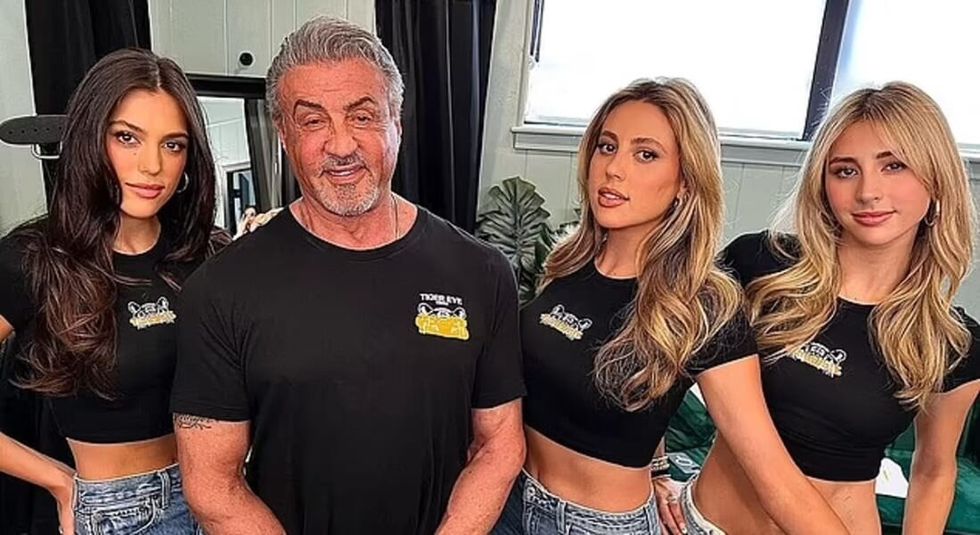 Sylvester Stallone and his three daughters wearing black shirts.