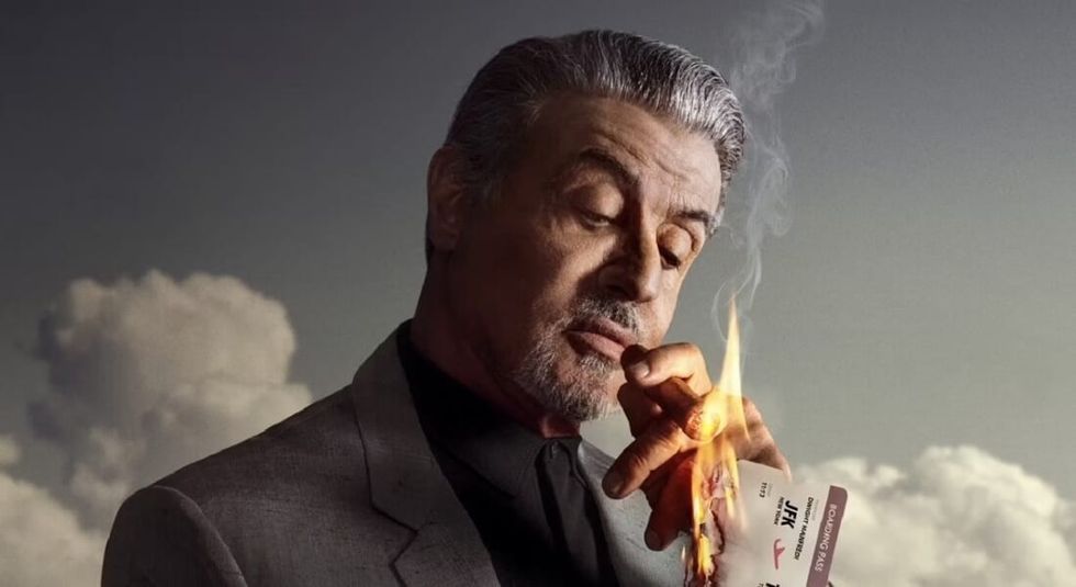 Sylvester Stallone smoking a cigar in a poster of his tv show Tulsa King.