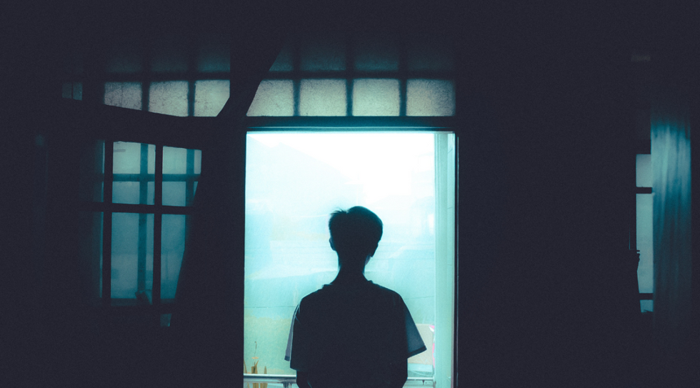 man looking out of window
