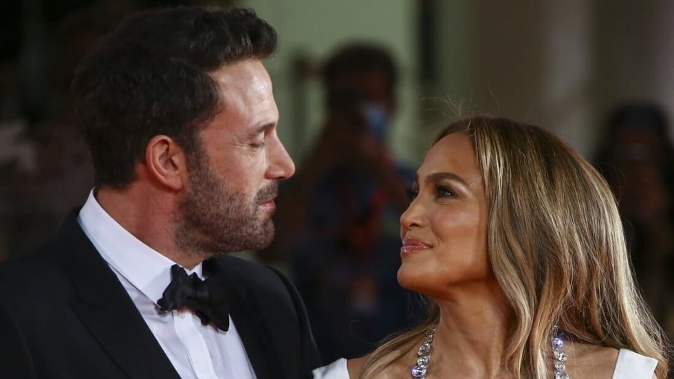 Jennifer Lopez and Ben Affleck smiling at one another.