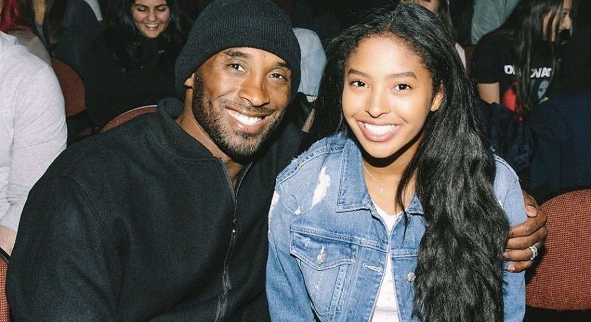 Kobe Bryant and daughter Natalia at a game with arms around one another.