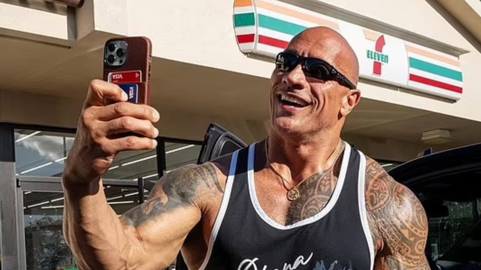 man in a black top taking a selfie