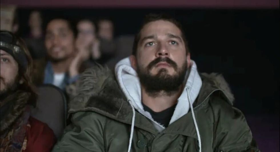 Shia LaBeouf watching a movie in a theatre.