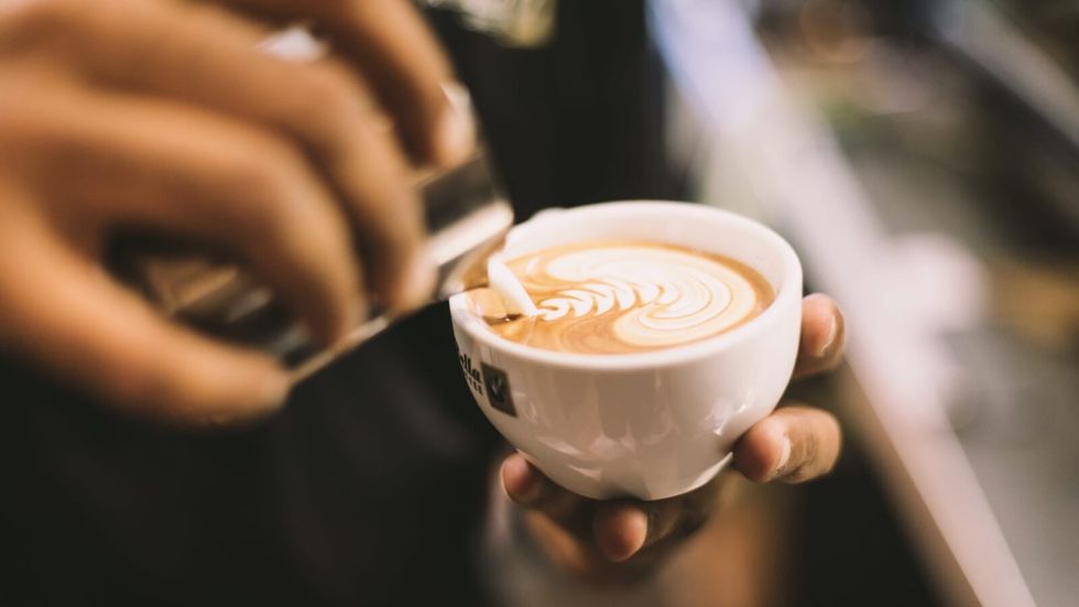 person holding a cup of coffee in their hands