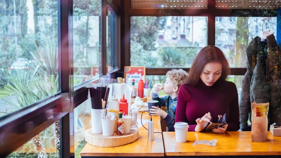 woman using her phone at a restaurant