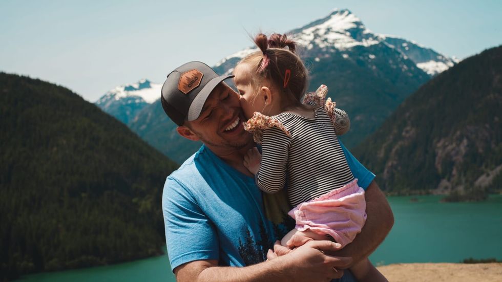 daughter kissing her dad on the cheek
