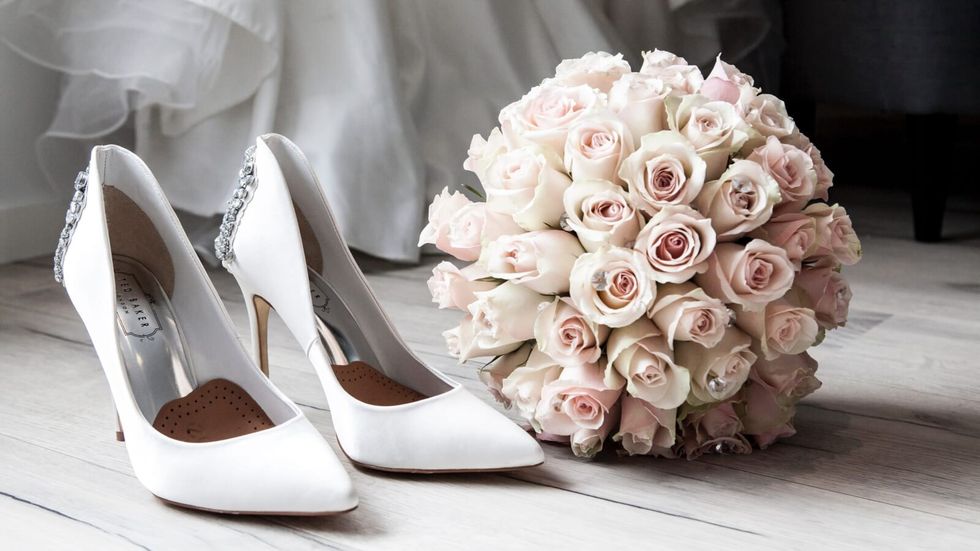 white high heels and a bouquet of roses