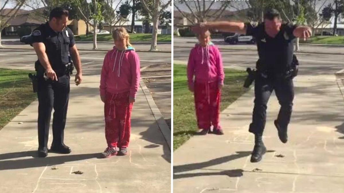 police officer and little girl playing hopscotch on the road