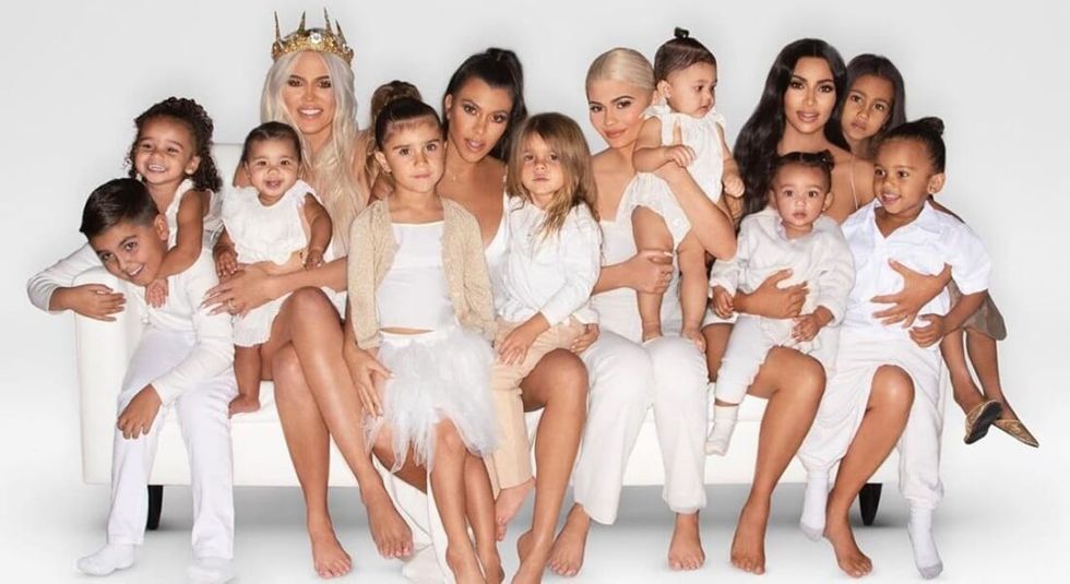 The entire Kardashian family wearing all white in family photo.