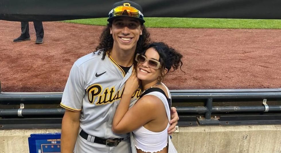 Vanessa Hudgens with baseball player Cole Tucker smiling during a game. 