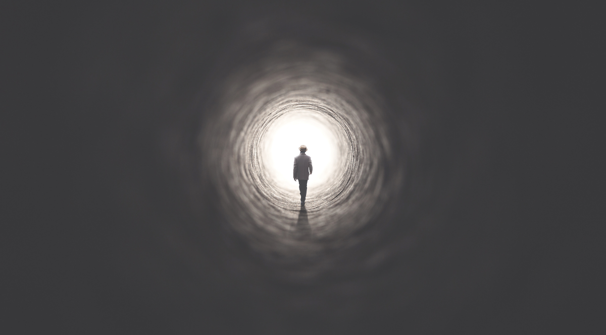 man walking in tunnel
