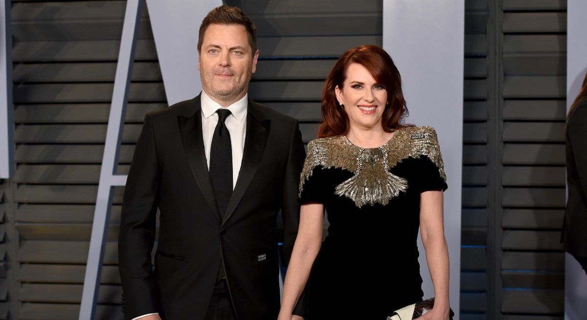 Megan Mullally and Nick Offerman holding hands on the red carpet.