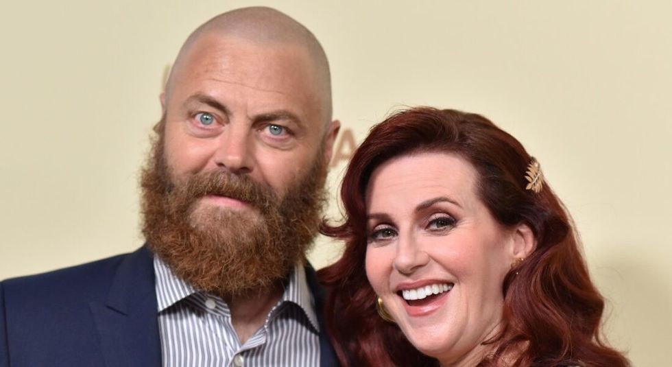 Mick Offerman and Megan Mullally smiling on the red carpet.