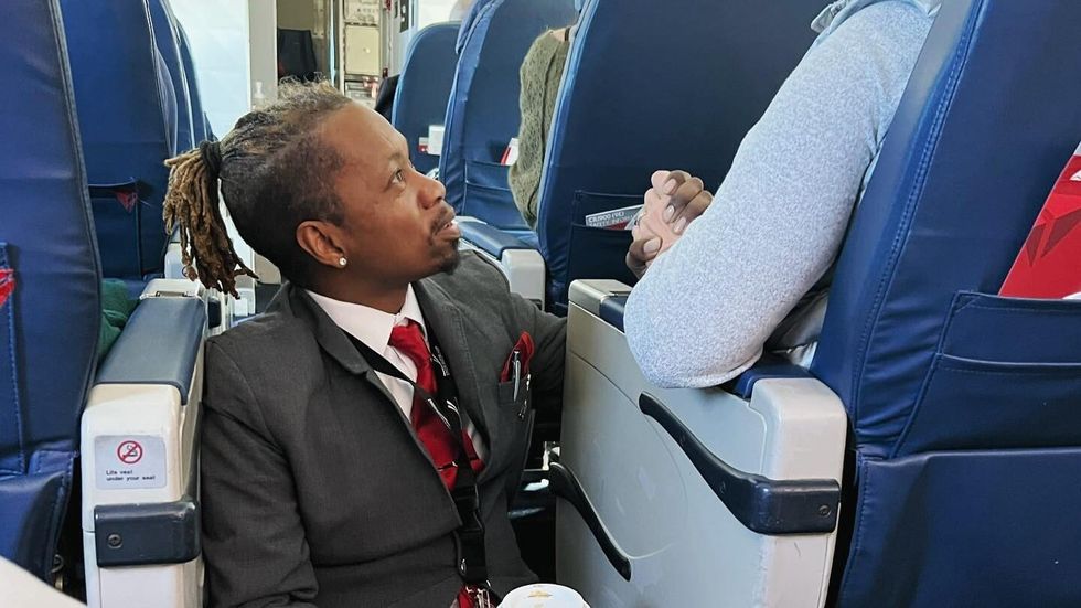flight attendant holding passenger's hand