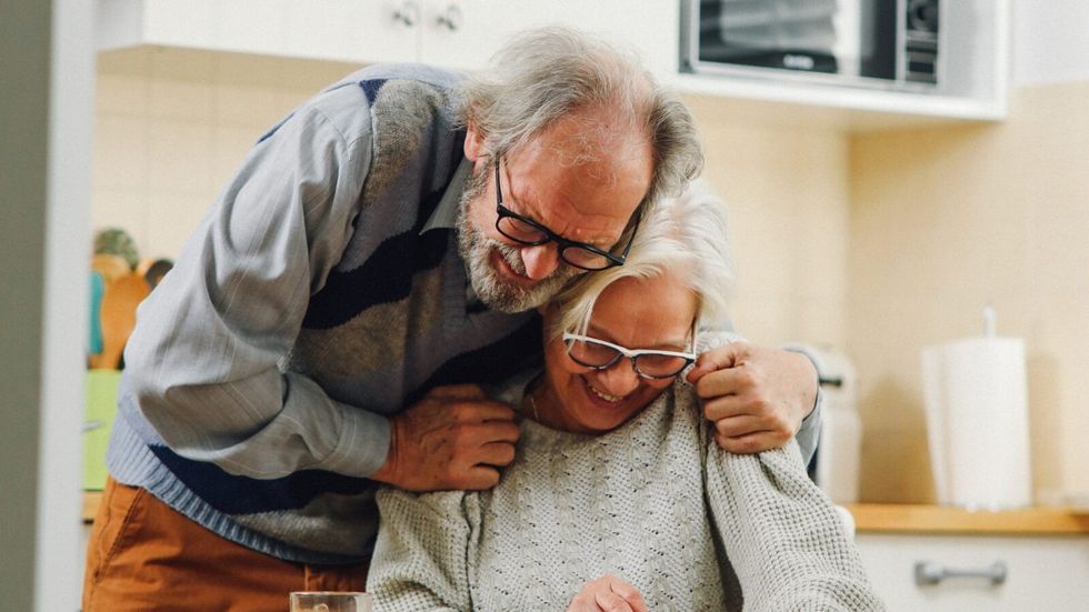 elderly couple hugging