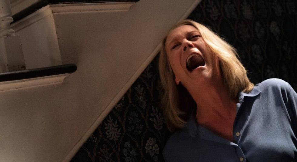 Jamie Lee Curtis screaming by a staircase in "Halloween Ends"