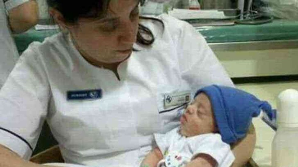 nurse holding a newborn baby boy